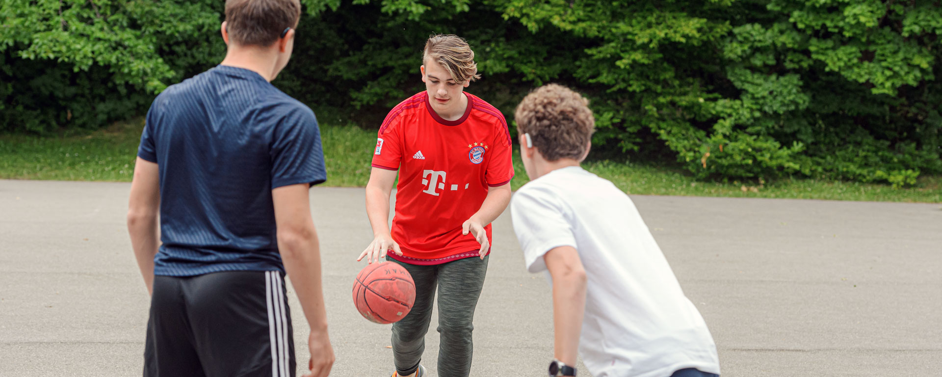 Augustinum Offene Ganztagsschule Slider Drei Schüler der offenen Ganztagsschule spielen Basketball