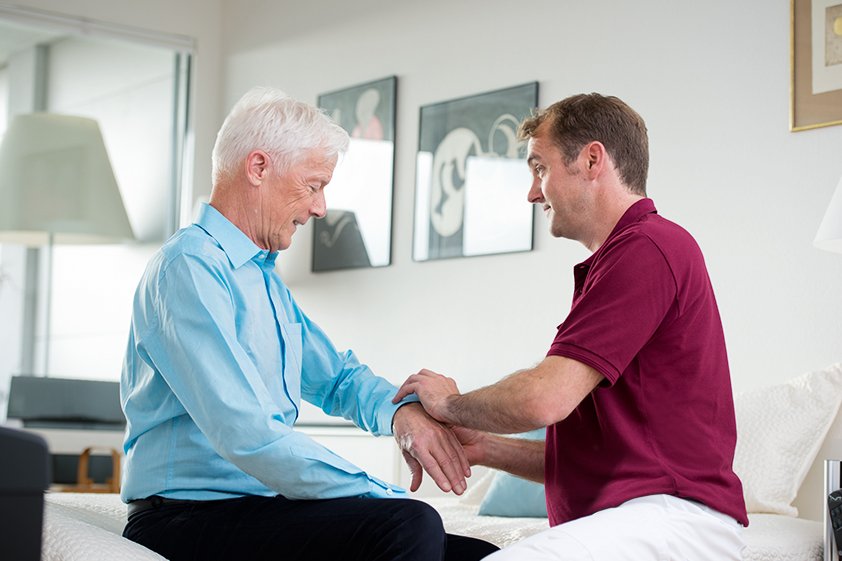 Augustinum Betreuung und Pflege Ein Pfleger des Augustinum pflegt einen Bewohner