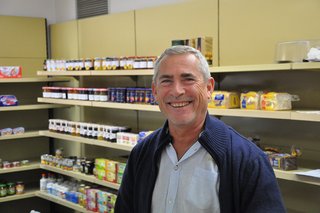 Augustinum Seniorenresidenz Freiburg Lebensmittel Ein lächelnder Mann vor einem Lebensmittelregal