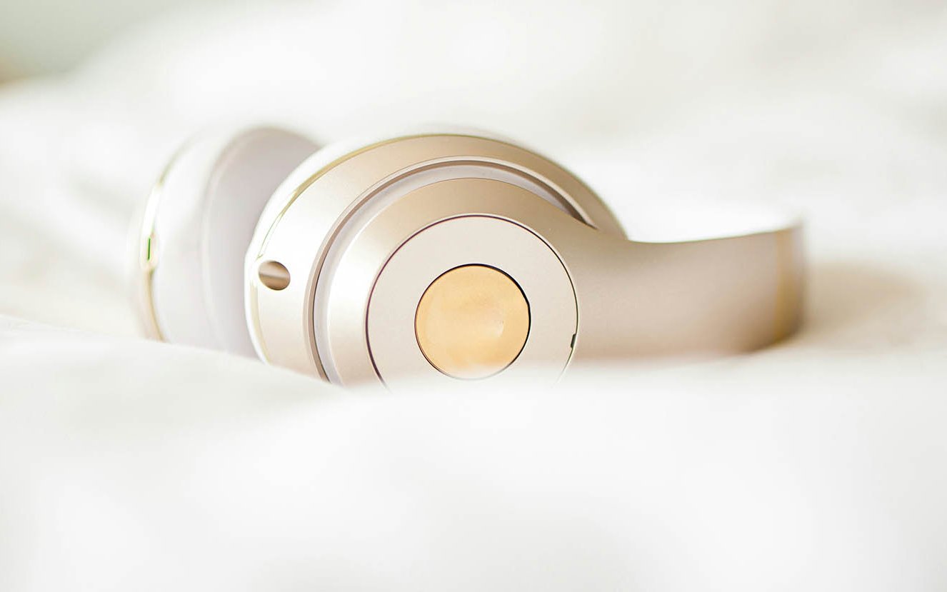 Kopfhörer liegt auf einer weichen Decke