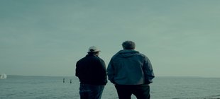 Habeck und Jessen, mit Rücken zur Kamera, blickend auf das Meer